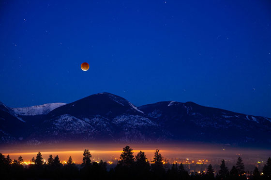 Lunar eclipse over mountains